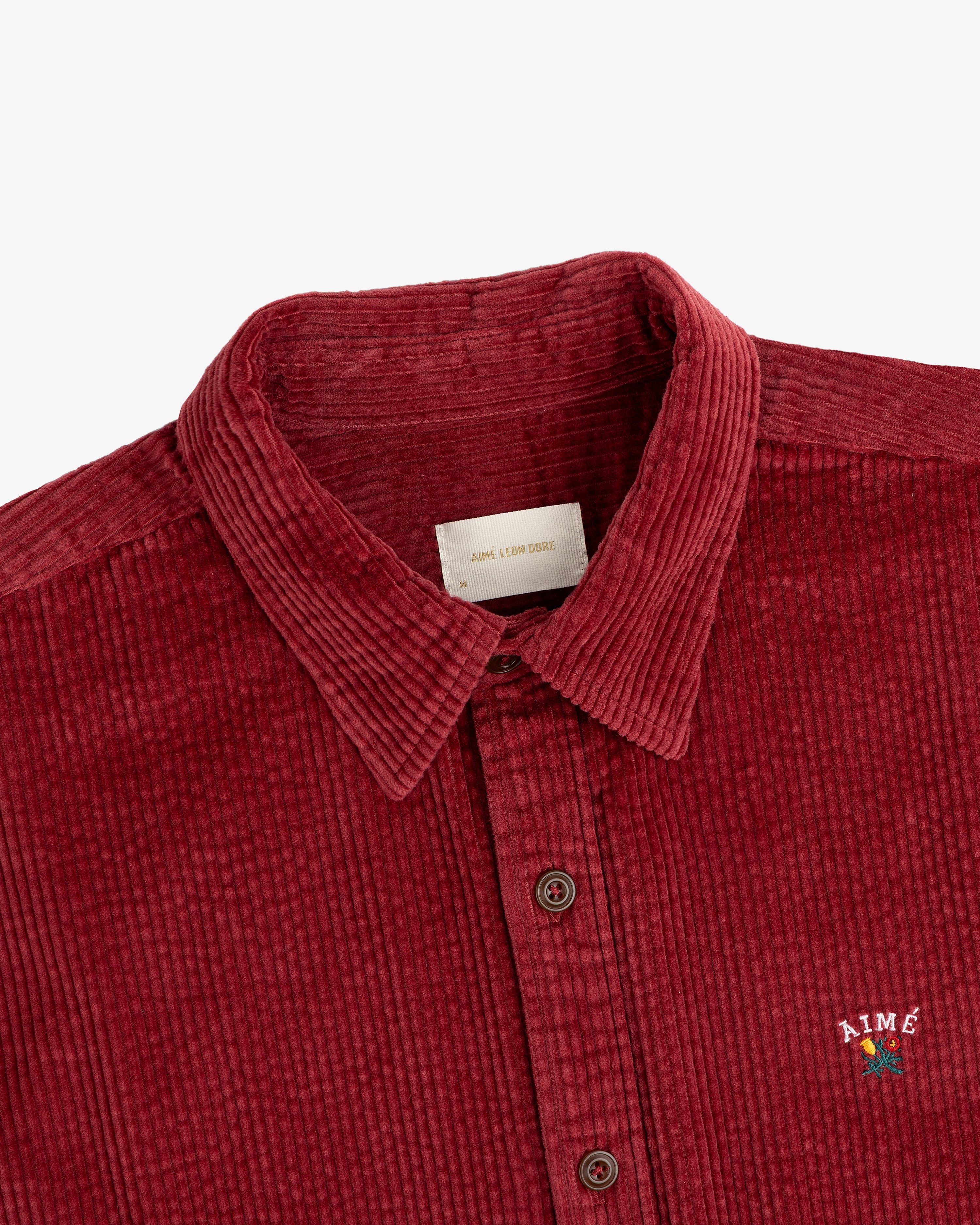 Burgundy Corduroy Leon Overshirt with a small floral embroidery on the chest.