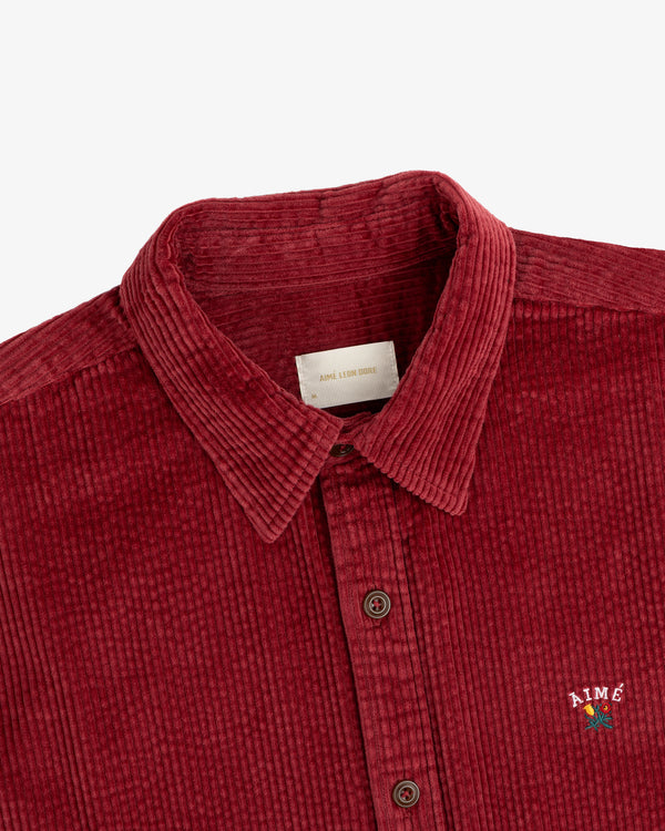 Burgundy Corduroy Leon Overshirt with a small floral embroidery on the chest.