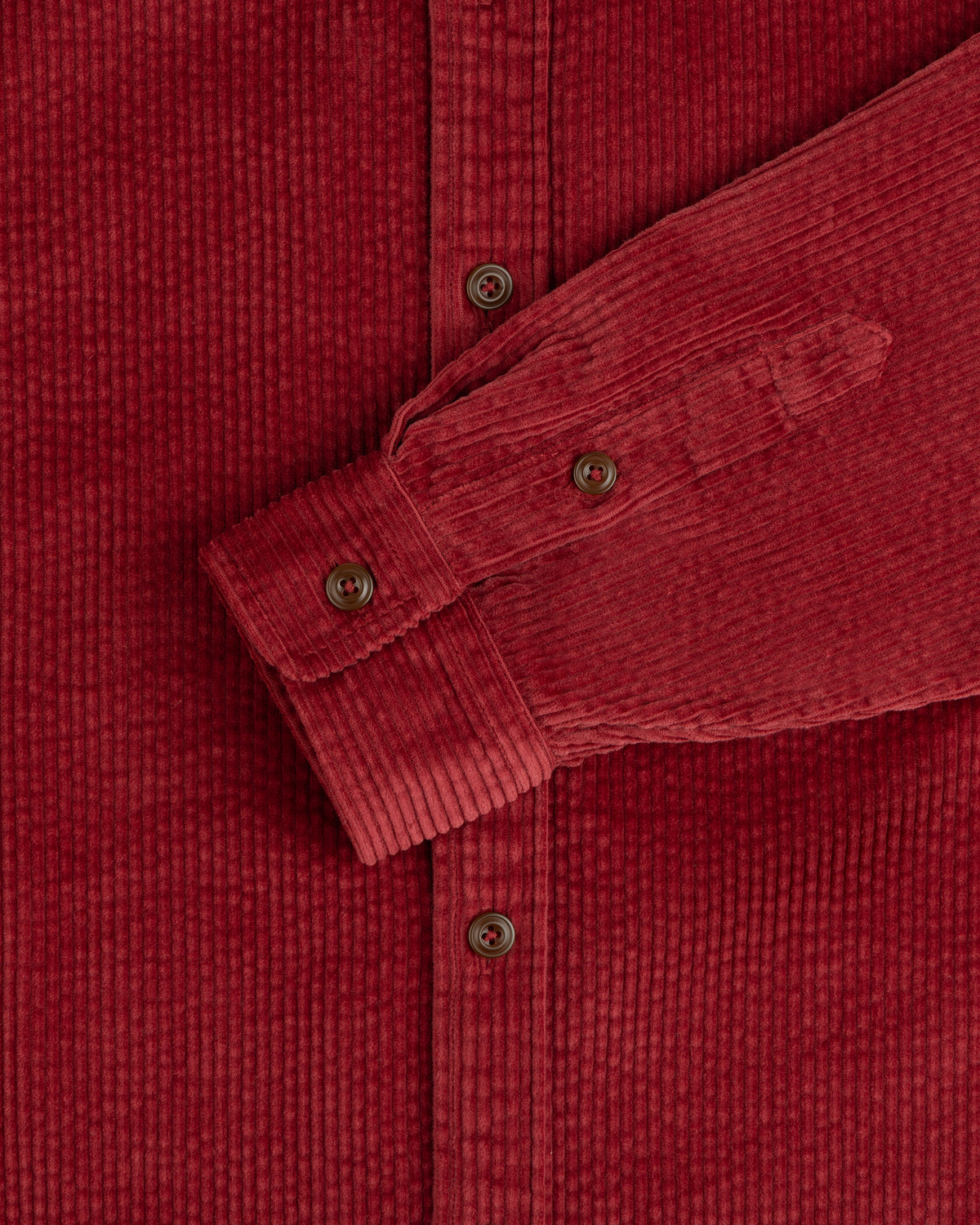 Corduroy Leon Overshirt in dark red corduroy, featuring a button-down front, cuffed sleeves, and brown buttons.