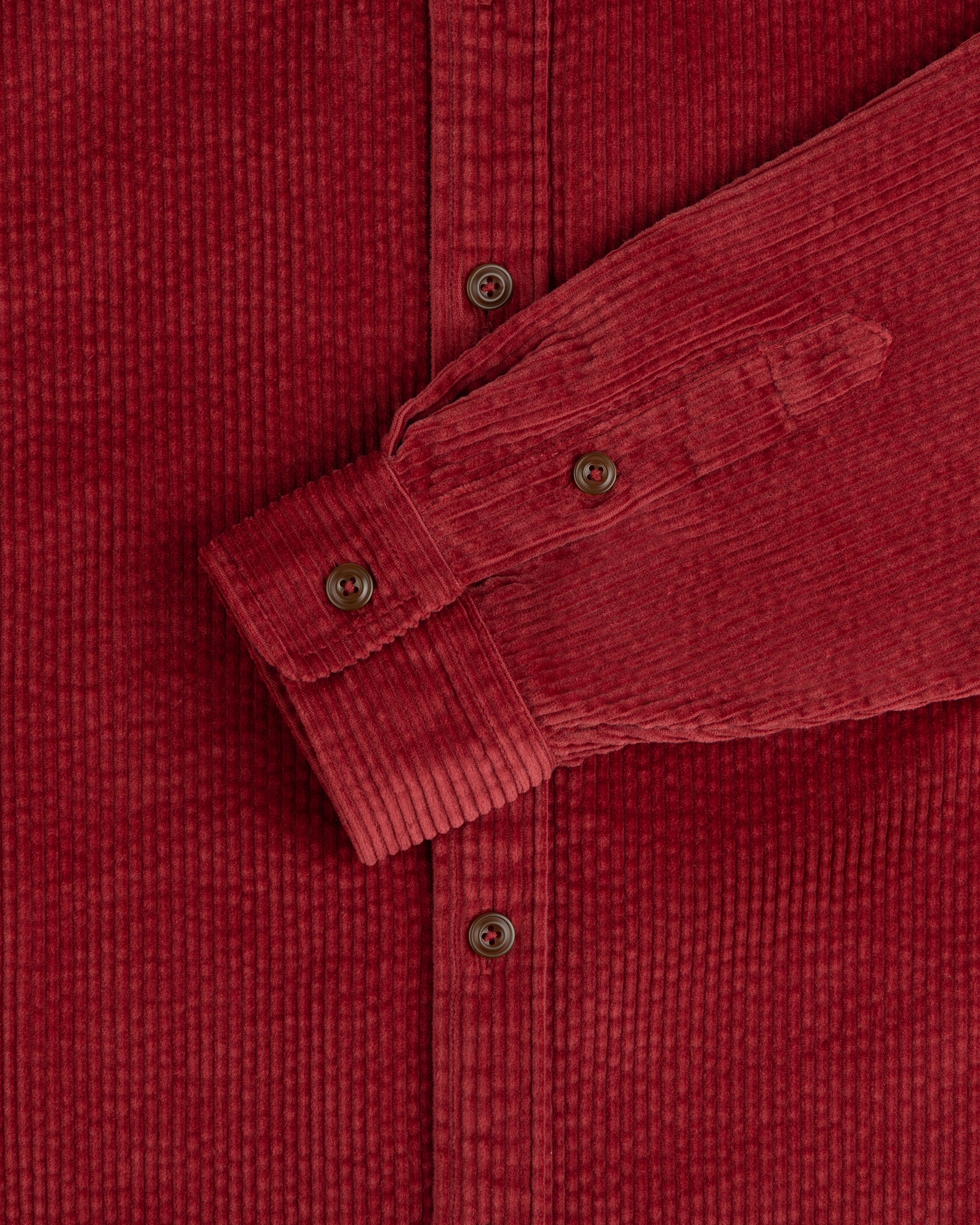 Corduroy Leon Overshirt in dark red corduroy, featuring a button-down front, cuffed sleeves, and brown buttons.