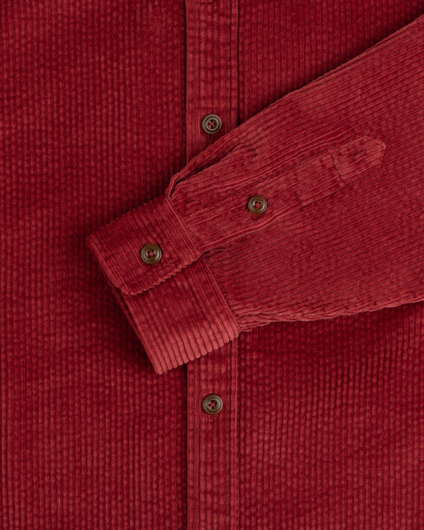 Corduroy Leon Overshirt in dark red corduroy, featuring a button-down front, cuffed sleeves, and brown buttons.