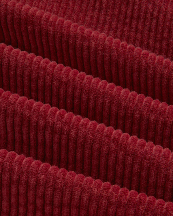 Deep red Corduroy Leon Overshirt fabric with thick, vertical ridges.