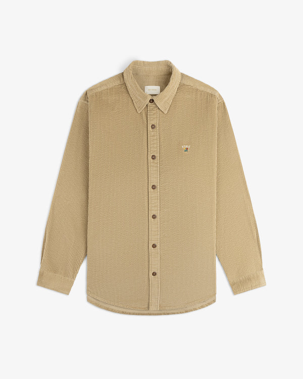 Tan long-sleeve Corduroy Leon Overshirt with a small embroidered graphic on the chest.