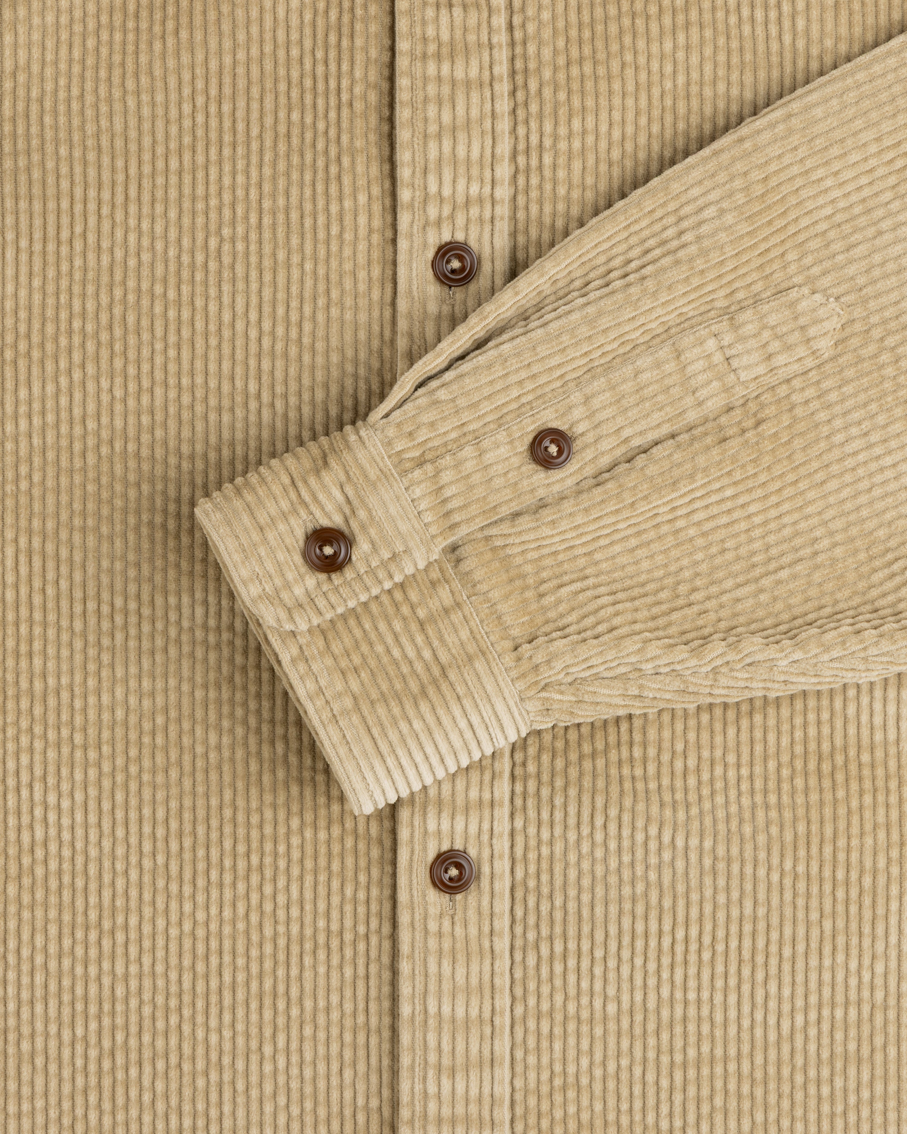 Corduroy Leon Overshirt in tan with brown buttons on the placket and sleeve cuff.