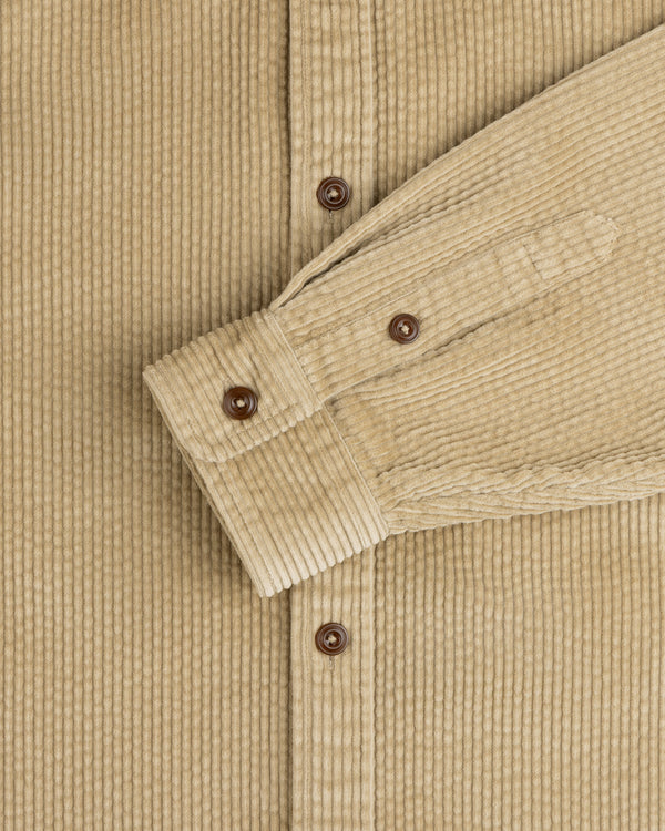 Corduroy Leon Overshirt in tan with brown buttons on the placket and sleeve cuff.