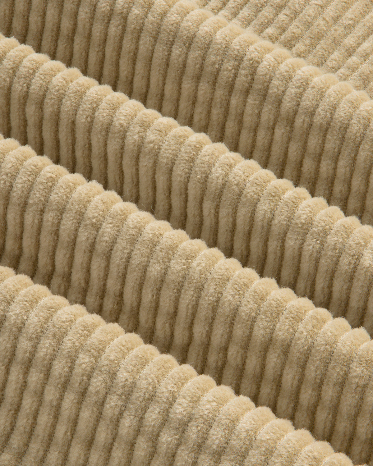 Close-up of the beige, wide-ridged corduroy fabric of the Corduroy Leon Overshirt.