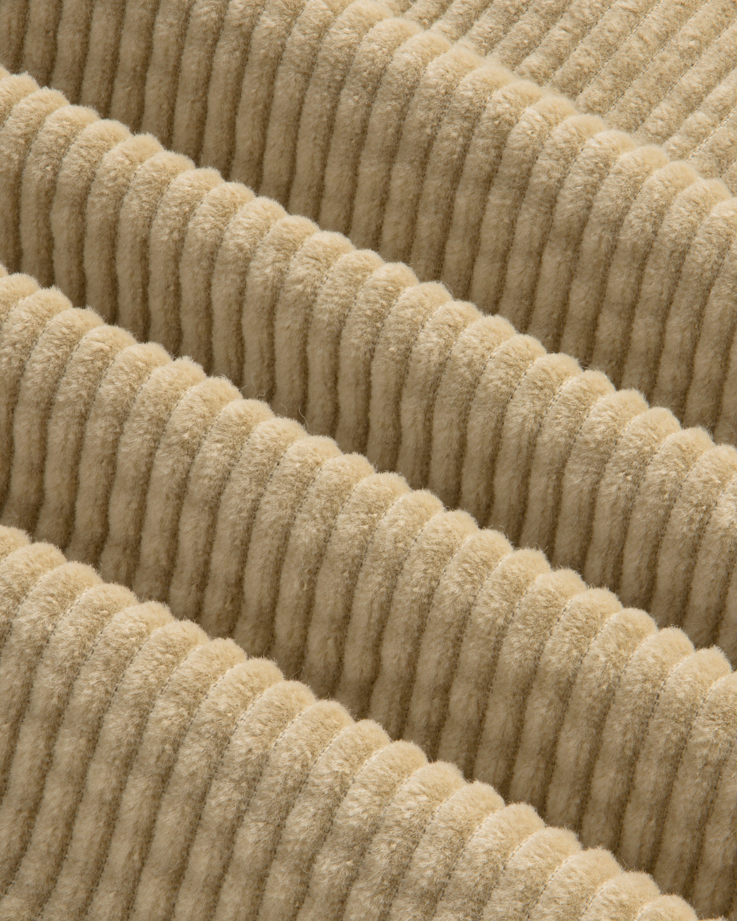 Close-up of the beige, wide-ridged corduroy fabric of the Corduroy Leon Overshirt.