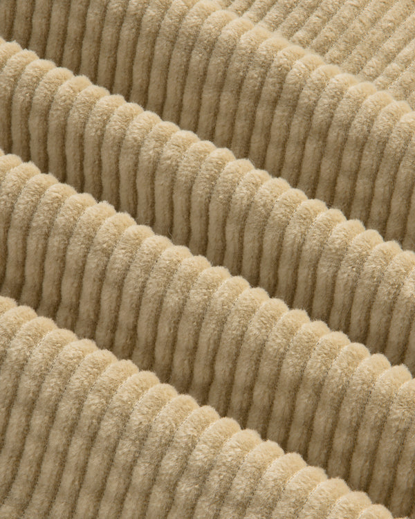 Close-up of the beige, wide-ridged corduroy fabric of the Corduroy Leon Overshirt.