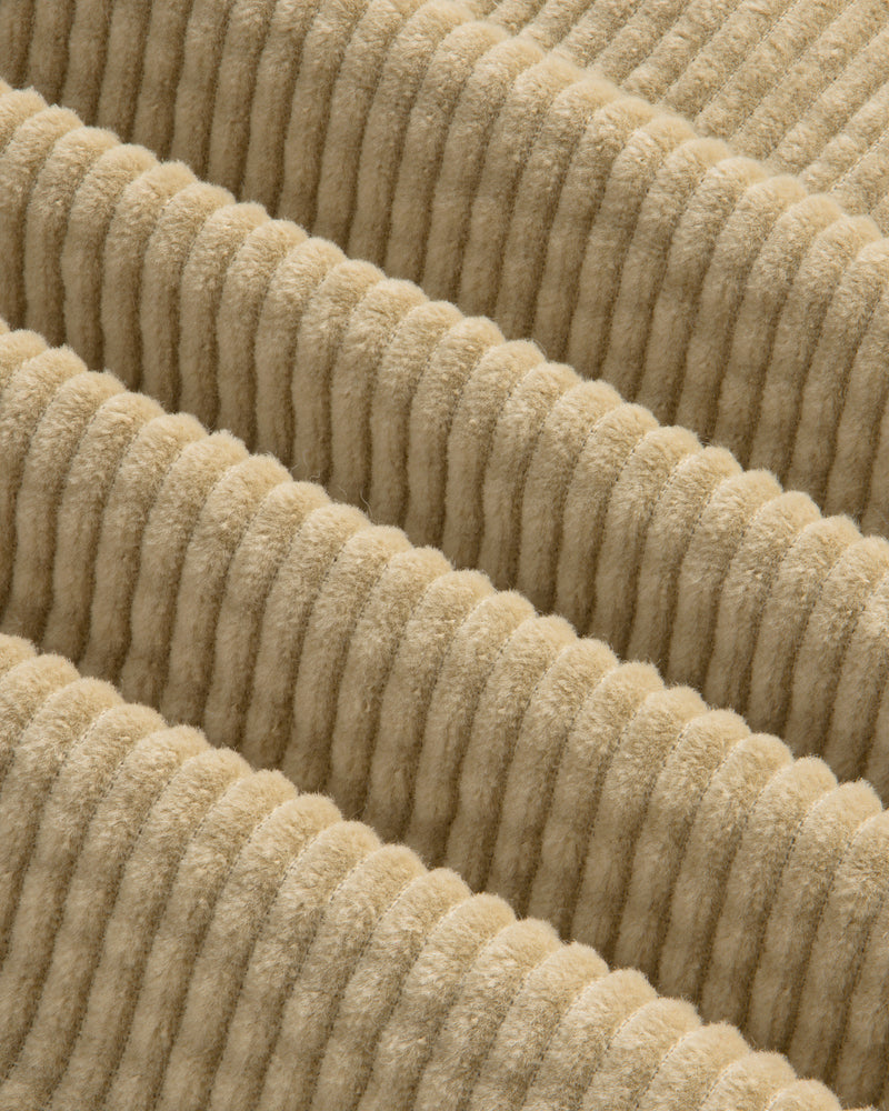 Close-up of the beige, wide-ridged corduroy fabric of the Corduroy Leon Overshirt.