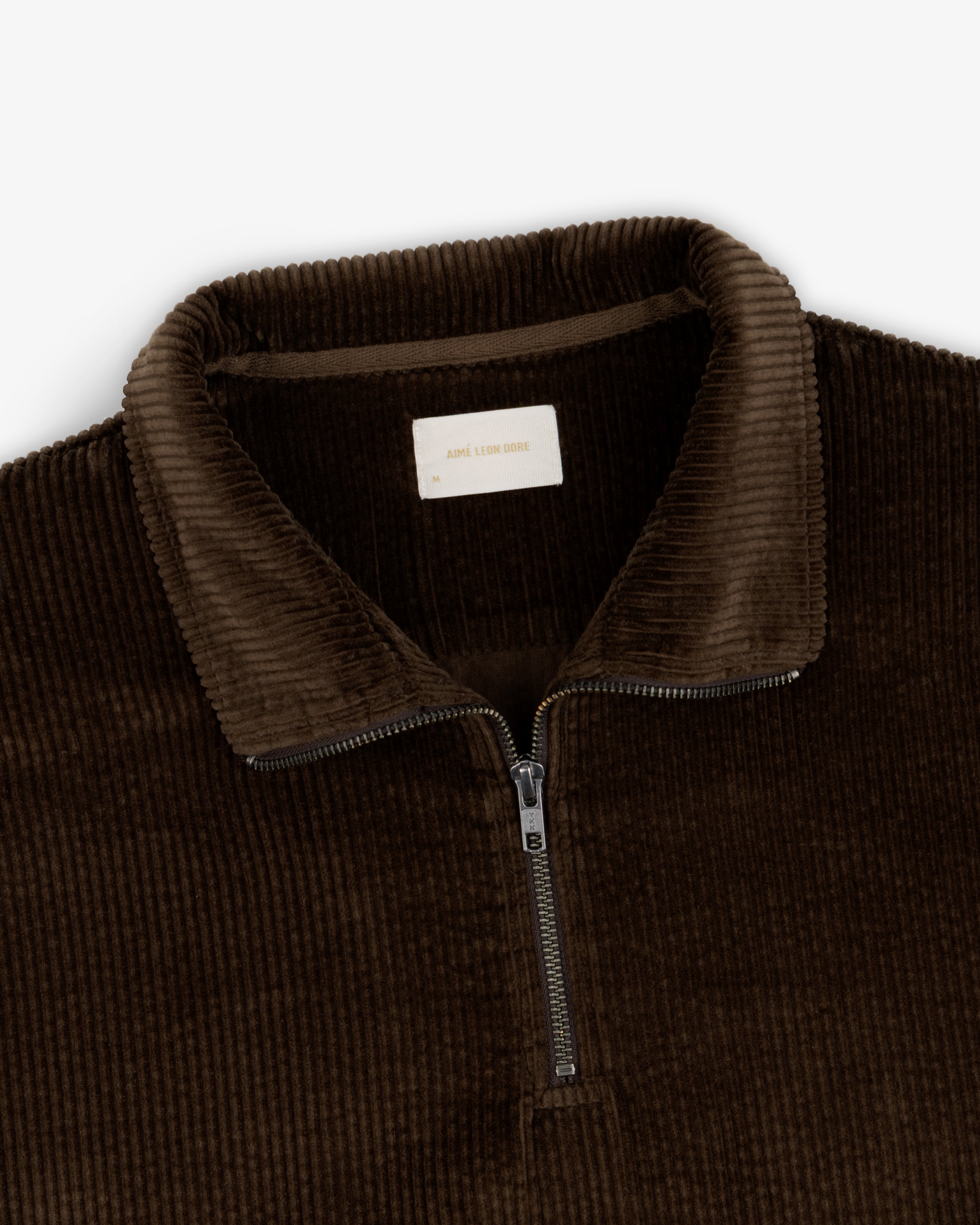 Dark brown Quarter Zip Corduroy Shirt featuring a metal zipper and a brand label at the collar.