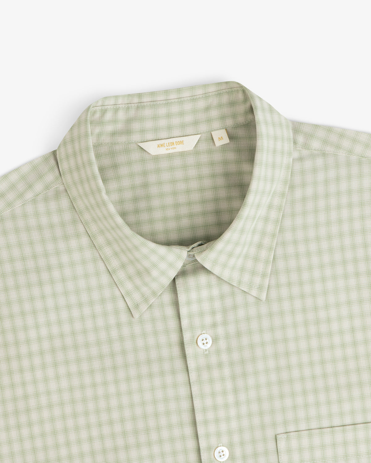 Plaid Casual Shirt in light green, size M, features a collar and button-up style. Shown from above.