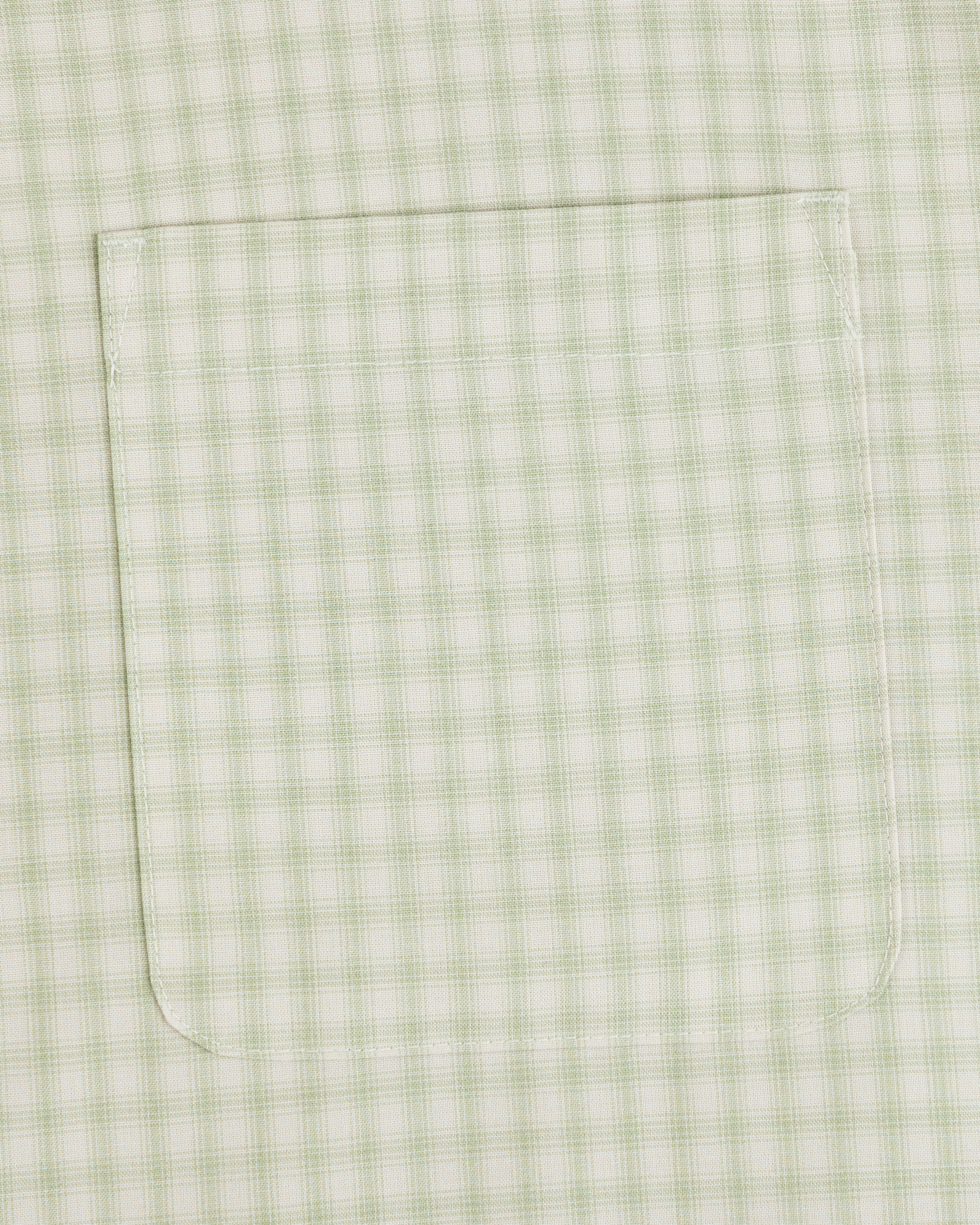 Close-up of Plaid Casual Shirt pocket, light green pattern with visible stitching on matching fabric.