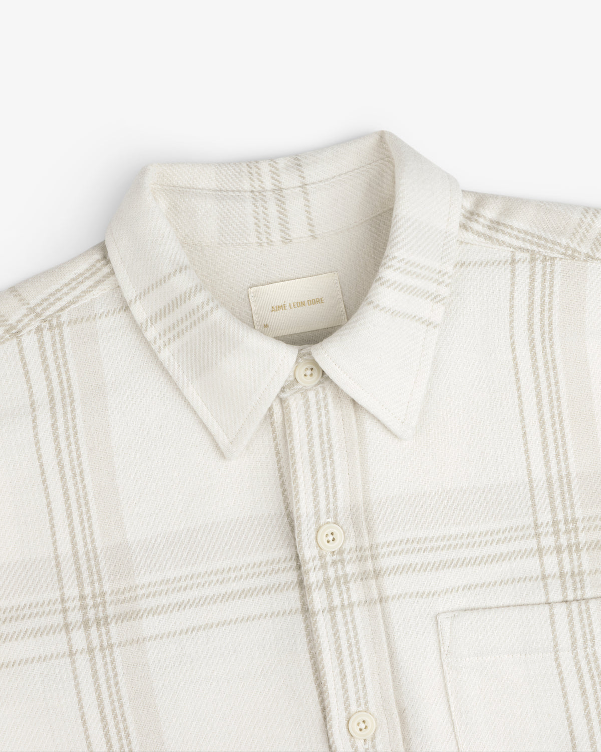 Yarn Dyed Plaid Overshirt: light-colored long-sleeve button-down with a subtle plaid pattern and a pointed collar.