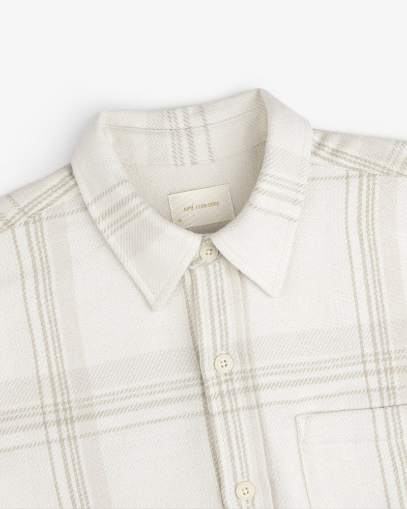 Yarn Dyed Plaid Overshirt: light-colored long-sleeve button-down with a subtle plaid pattern and a pointed collar.