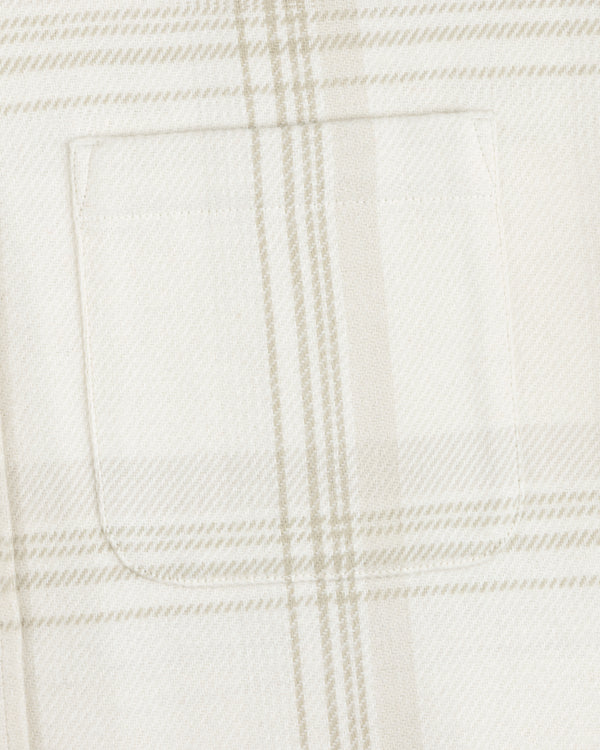 Close-up of a chest pocket on the Yarn Dyed Plaid Overshirt in white and beige.