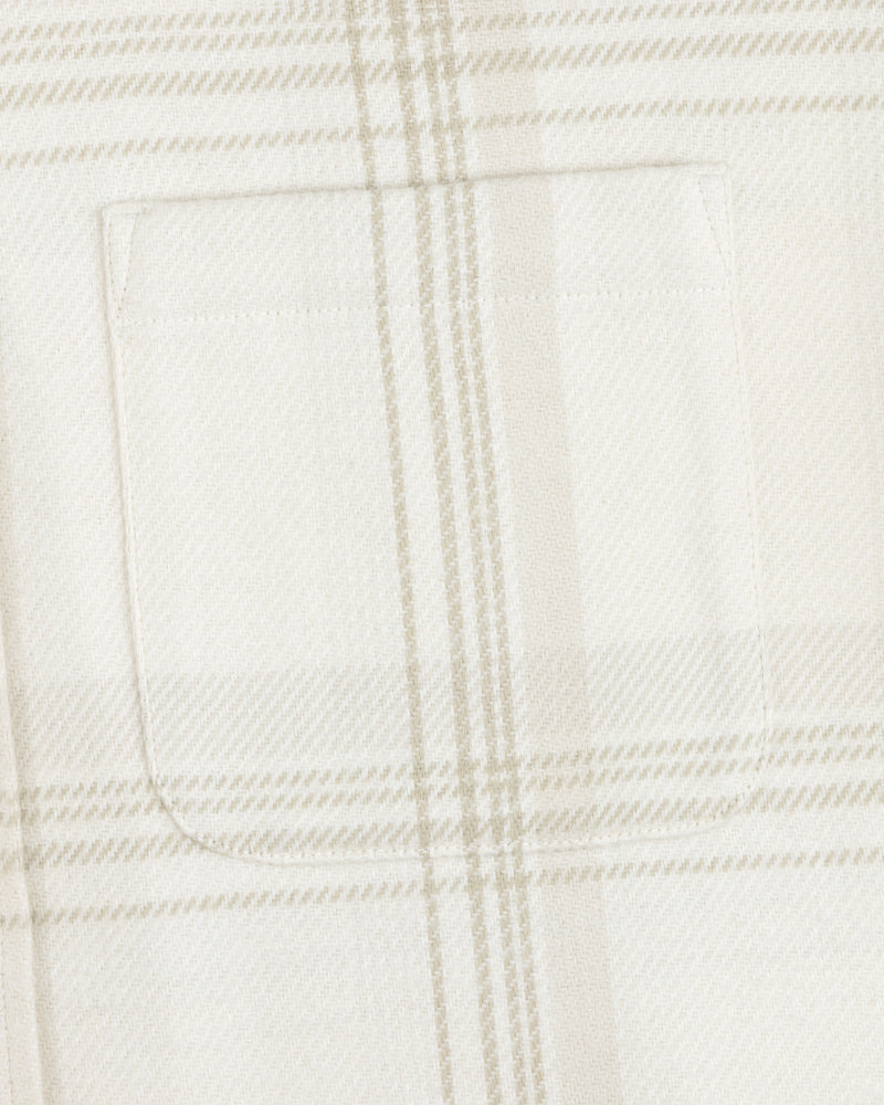Close-up of a chest pocket on the Yarn Dyed Plaid Overshirt in white and beige.