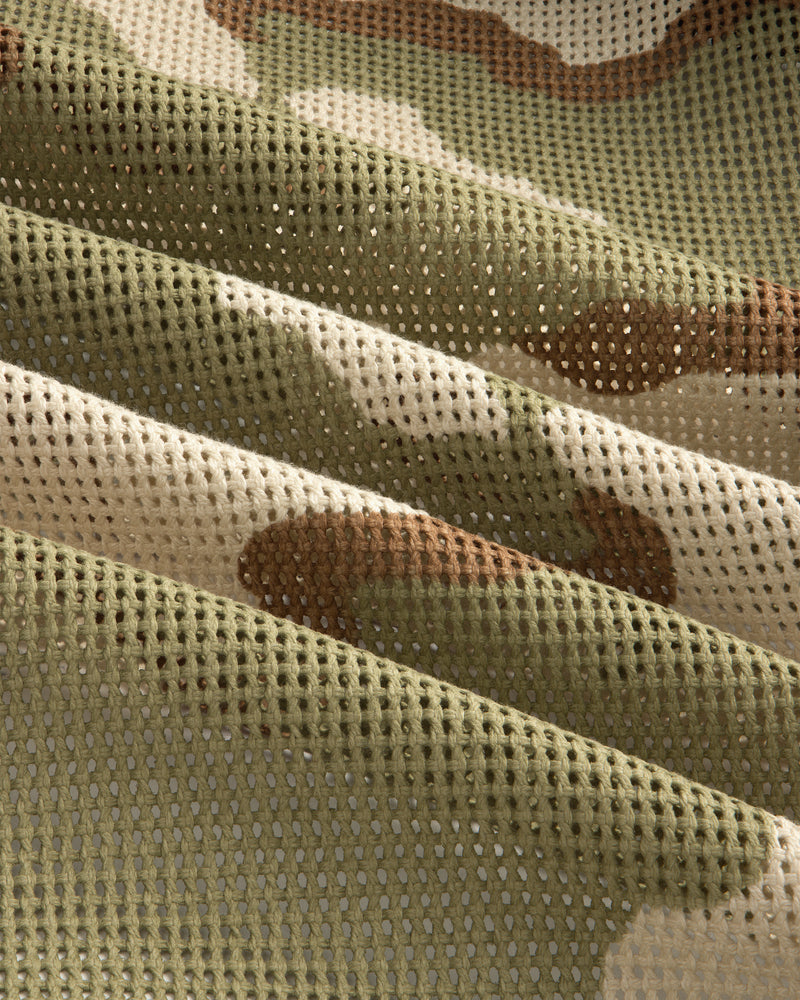 Folded green, tan, and brown camouflage mesh fabric of the Camo Mesh Zip Overshirt.