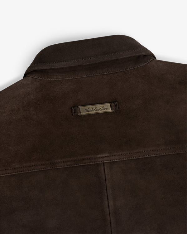 Back view of a dark brown Suede Overshirt featuring a branded metal label at the center of the collar.