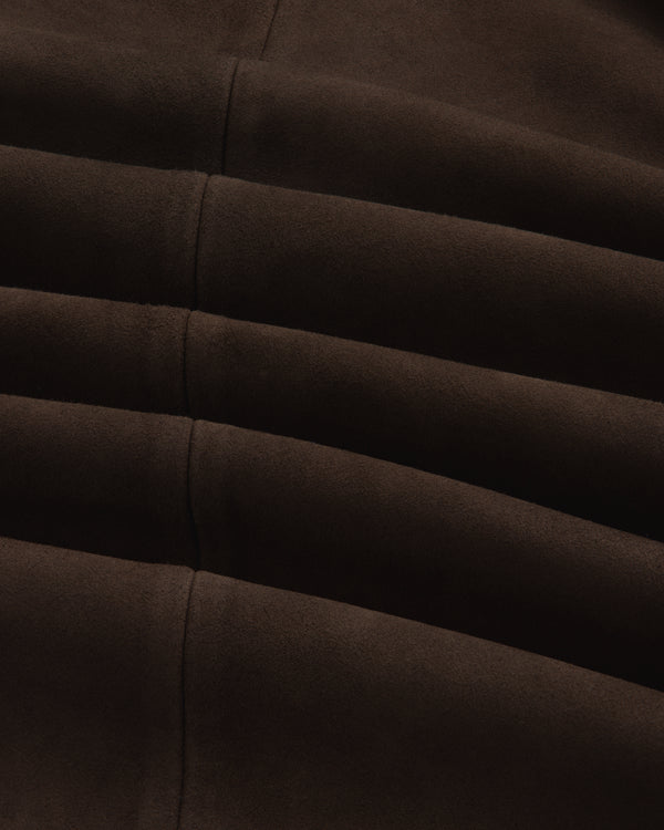 Close-up of the dark brown Suede Overshirt showing its fabric texture, seams, and folds.