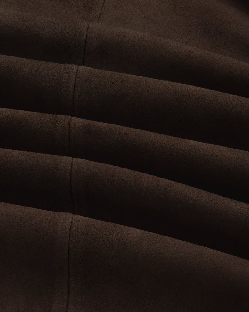 Close-up of the dark brown Suede Overshirt showing its fabric texture, seams, and folds.