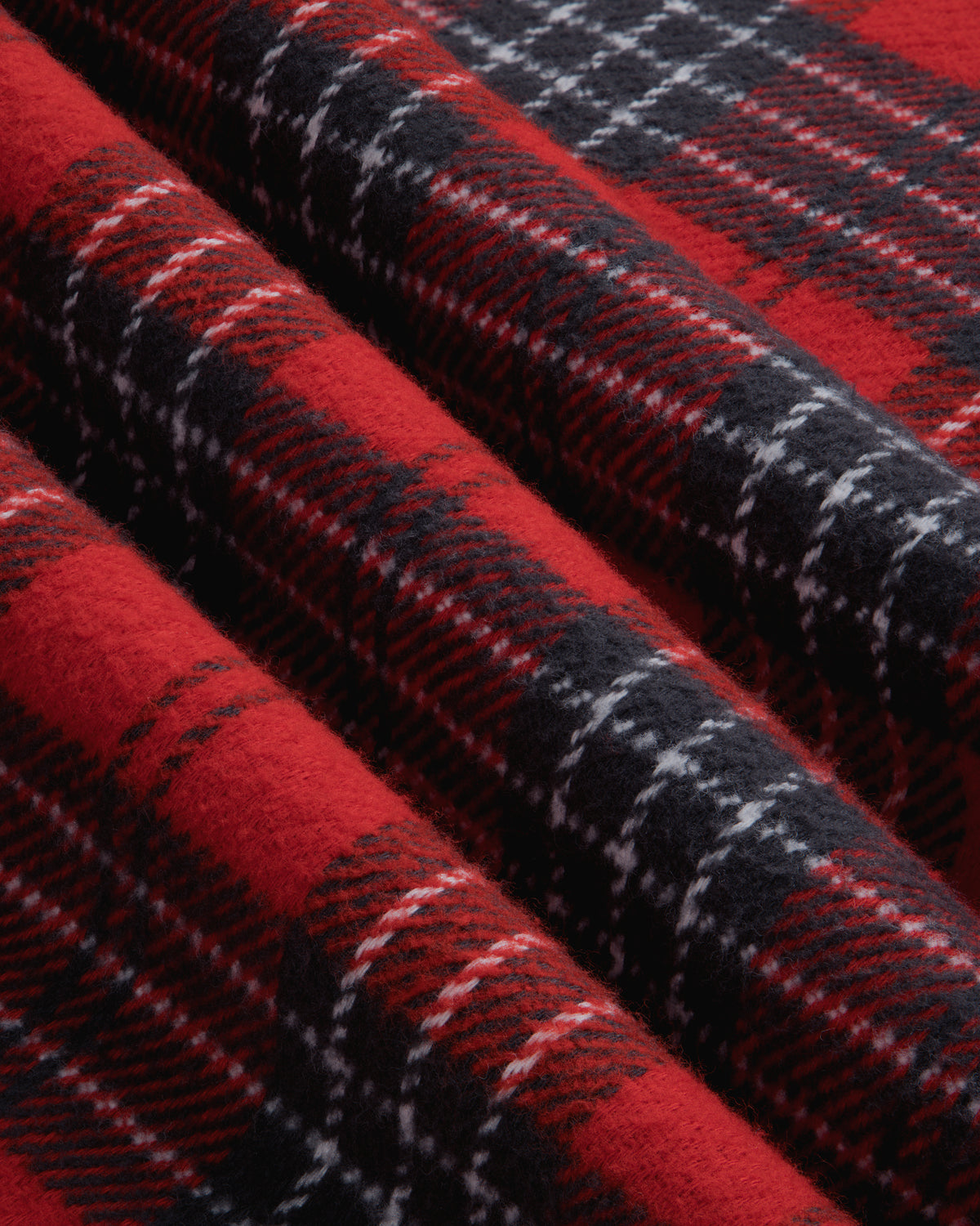 Folded red, black, and white Yarn Dyed Plaid Overshirt fabric.