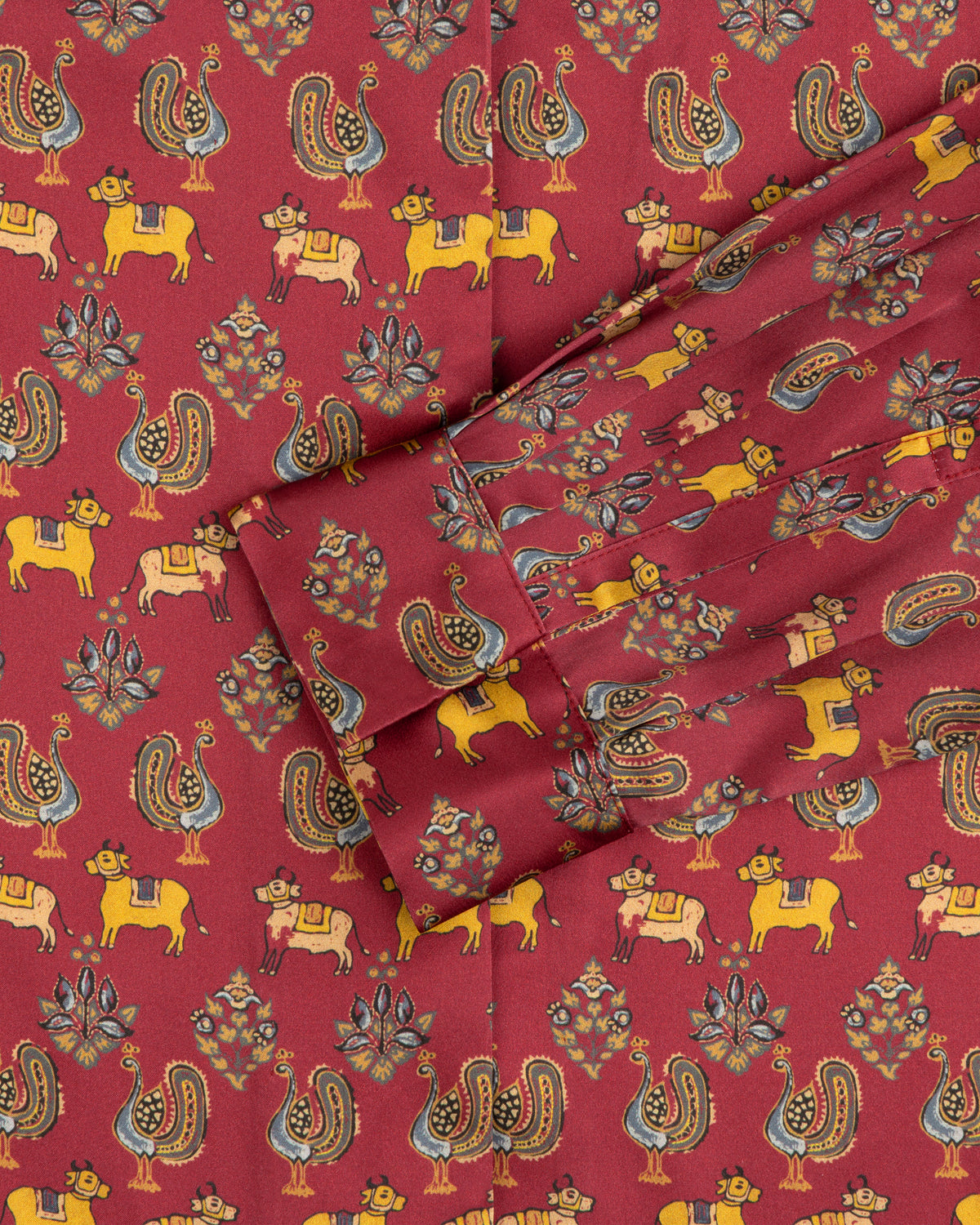 Archival Print Silk Tie Neck Blouse in red with yellow cows, stylized birds, and floral motifs.