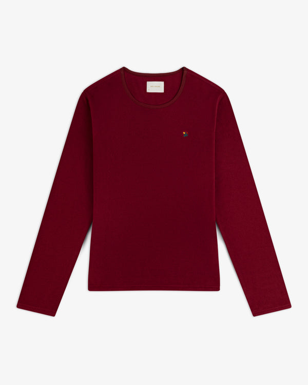 Deep red Crest Long-Sleeve Fleece Tee with a small multicolored floral embroidery on the chest.