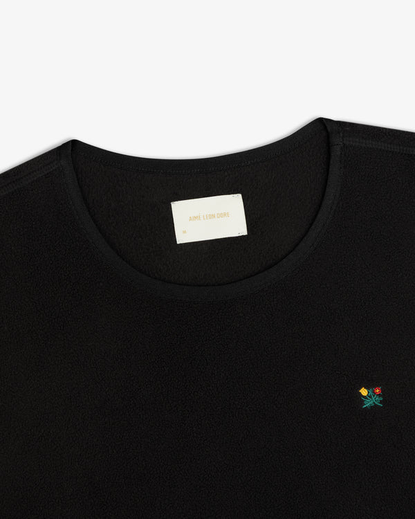 Black Crest Long-Sleeve Fleece Tee with small floral embroidery on the chest and an inner neckline brand label.