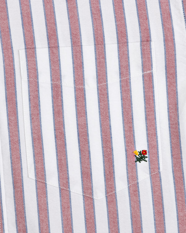 Striped Crest Oxford Shirt: white with red/blue stripes, chest pocket, and small yellow/red flower embroidery.
