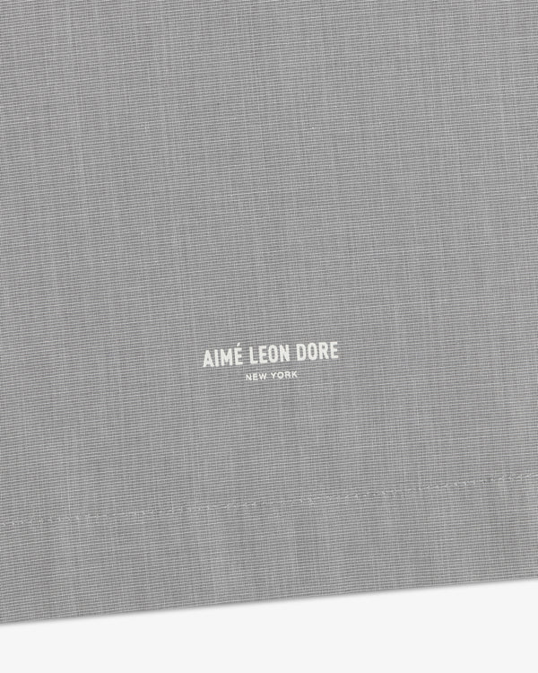 Gray Poplin Casual Shirt with small white Aimé Leon Dore New York text near the stitched hem.