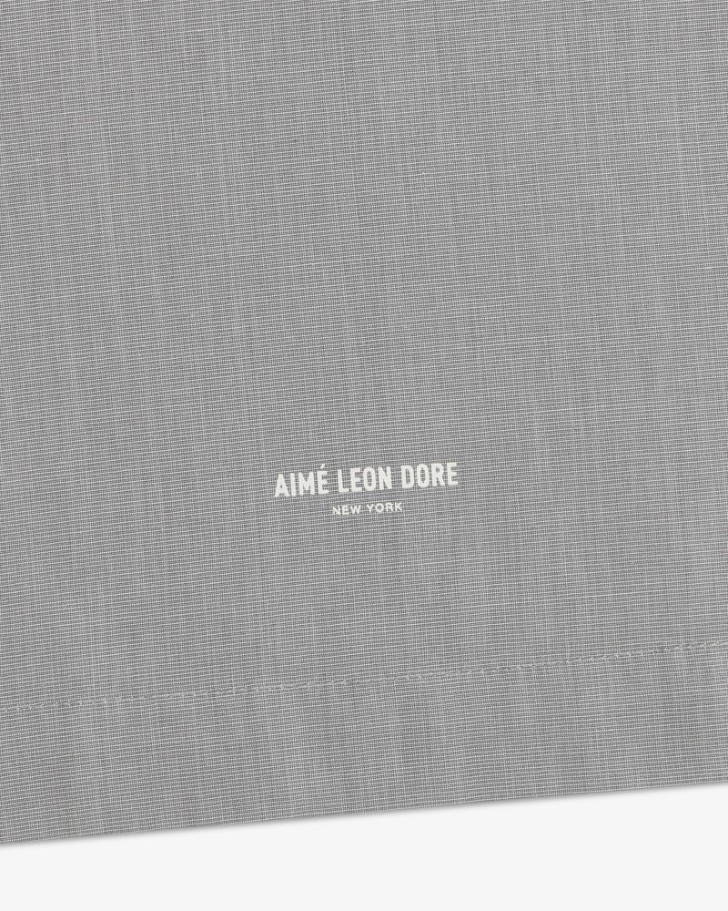Gray Poplin Casual Shirt with small white Aimé Leon Dore New York text near the stitched hem.