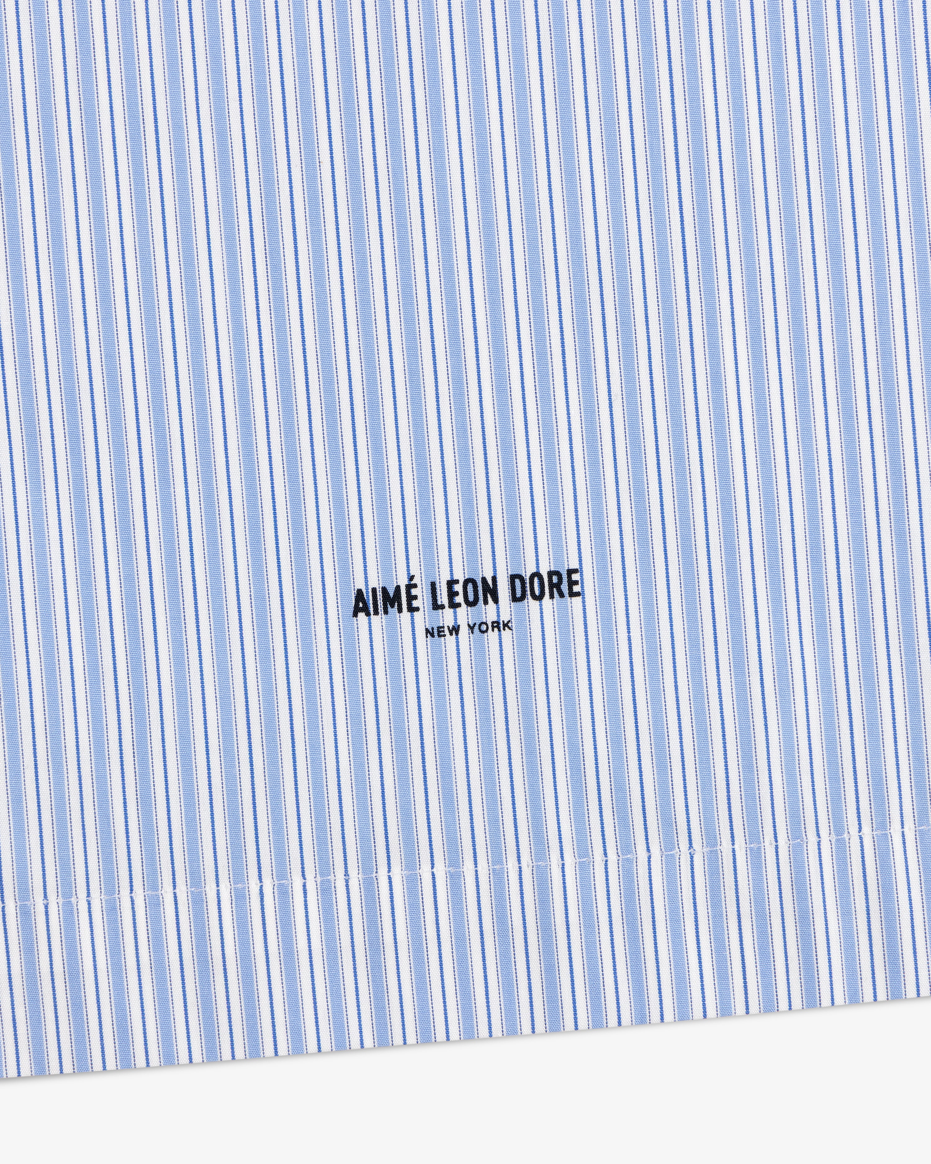 Poplin Casual Shirt in blue and white stripes with AIMÉ LEON DORE NEW YORK text embroidered in black.