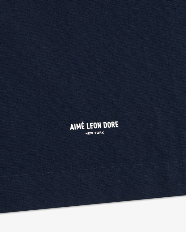 Close-up of navy Poplin Casual Shirt with AIMÉ LEON DORE NEW YORK in small white print near the bottom.