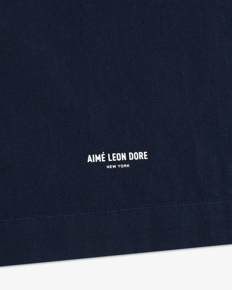 Close-up of navy Poplin Casual Shirt with AIMÉ LEON DORE NEW YORK in small white print near the bottom.