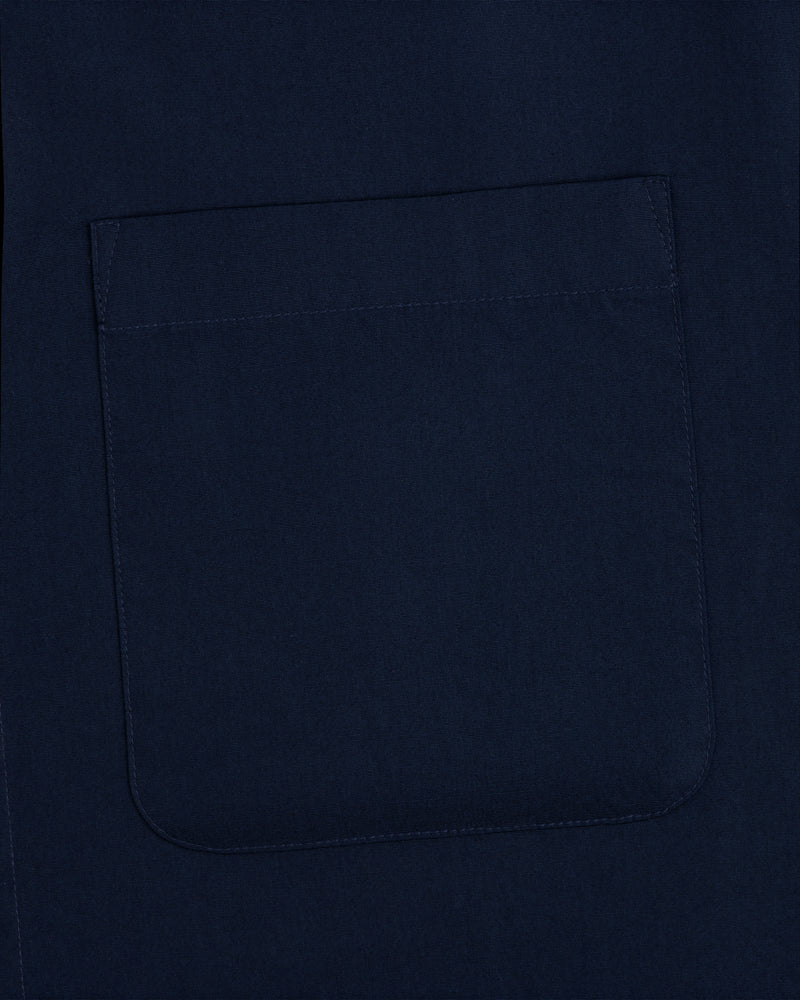 Close-up of a navy Poplin Casual Shirt fabric featuring a stitched square pocket.