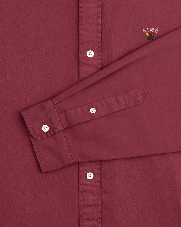 Maroon Garment Dyed Leon Overshirt with long sleeves, AIMÉ and small flower embroidery near the shoulder.