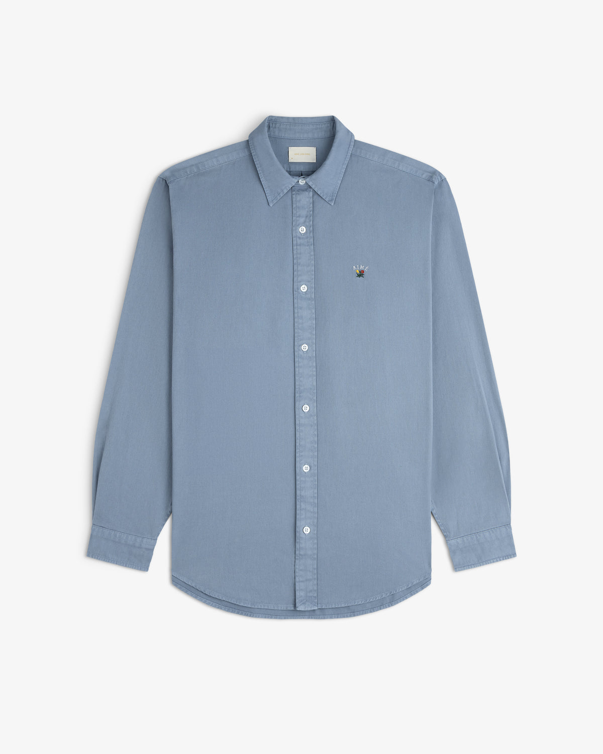 Garment Dyed Leon Overshirt in light blue with long sleeves and chest logo, shown on a white background.