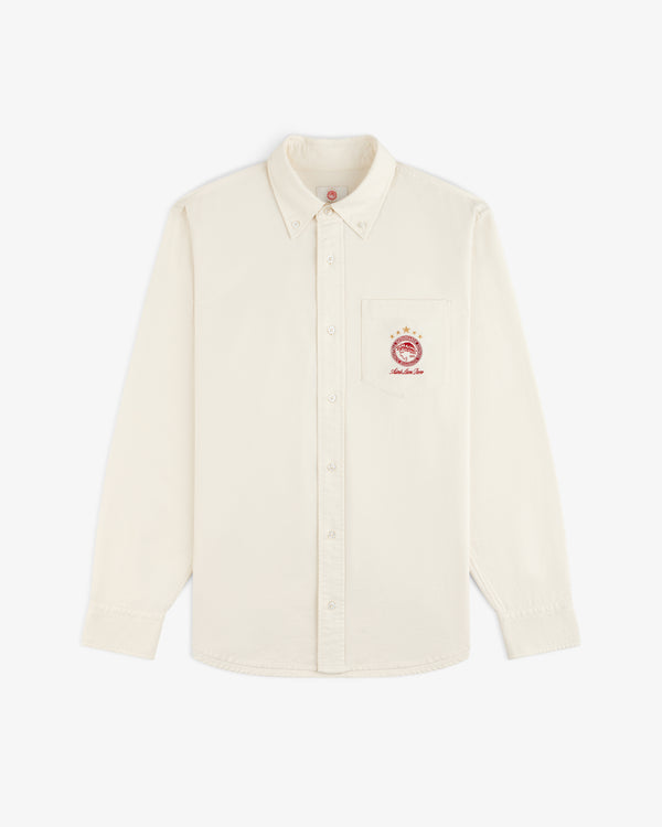 Cream-colored long-sleeve ALD / Olympiacos F.C. Logo Oxford Shirt with an embroidered sports crest on the chest pocket.