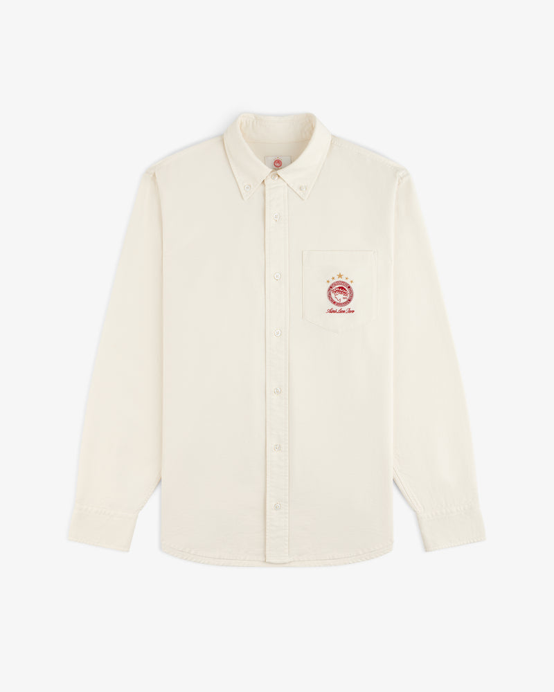 Cream-colored long-sleeve ALD / Olympiacos F.C. Logo Oxford Shirt with an embroidered sports crest on the chest pocket.