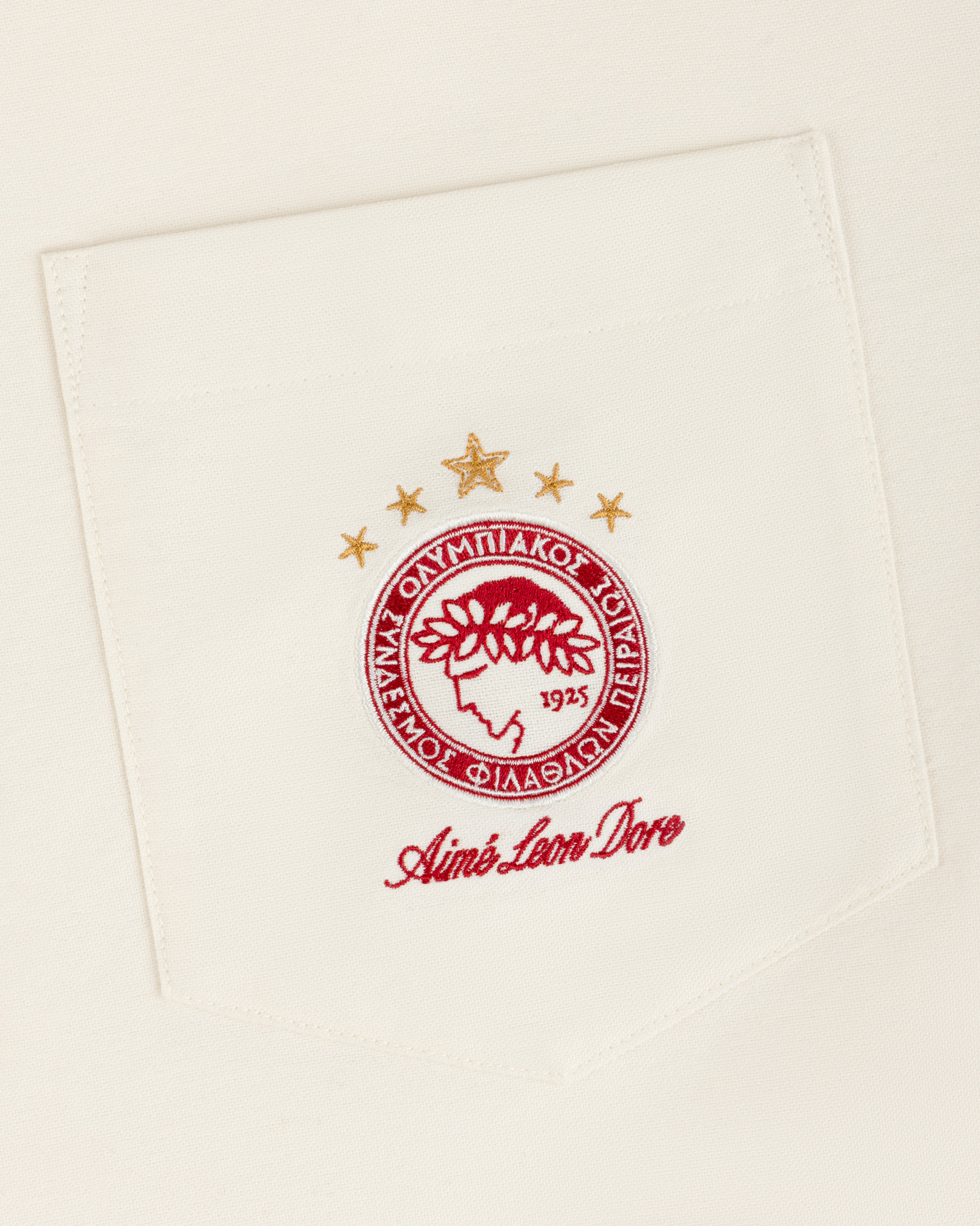 ALD / Olympiacos F.C. Logo Oxford Shirt featuring a chest pocket with an embroidered team logo and Aimé Leon Dore text.