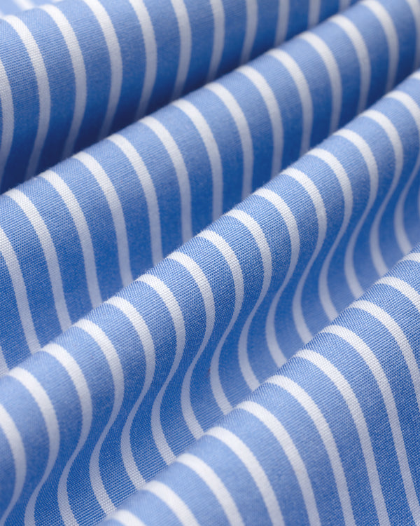 Striped Button Down Poplin Shirt fabric in blue and white vertical stripes, folded in soft waves.