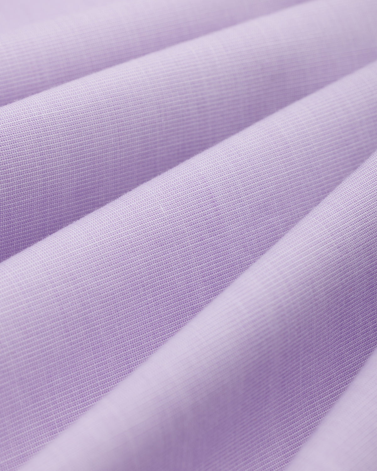 Close-up of folds in the light purple Button Down Poplin Shirt fabric.