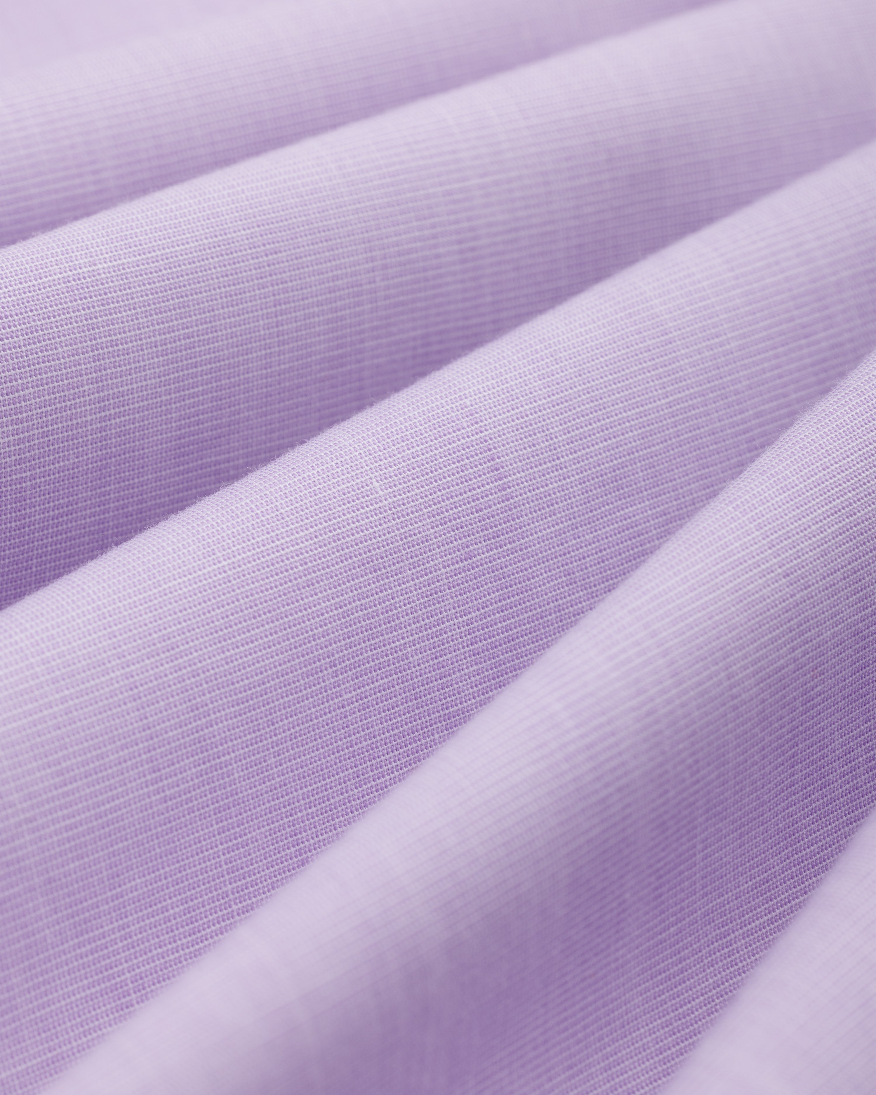 Close-up of folds in the light purple Button Down Poplin Shirt fabric.