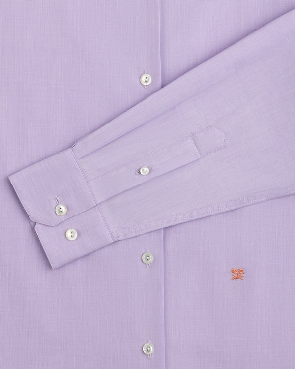 Close-up of a light purple Button Down Poplin Shirt with a buttoned cuff and a small embroidered logo on the chest.