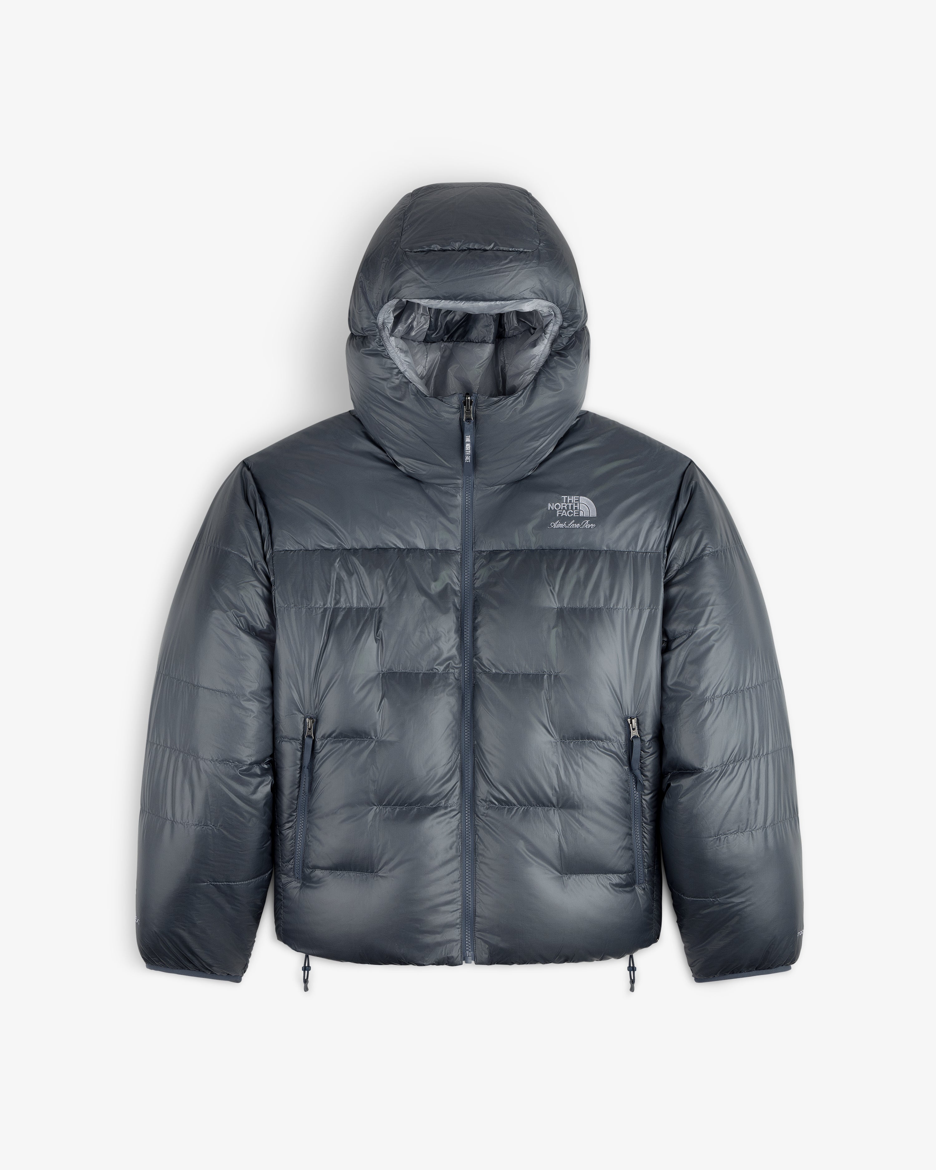 ALD / The North Face Reversible Pertex® Nuptse Jacket with hood, front zip, and side pockets on white background.
