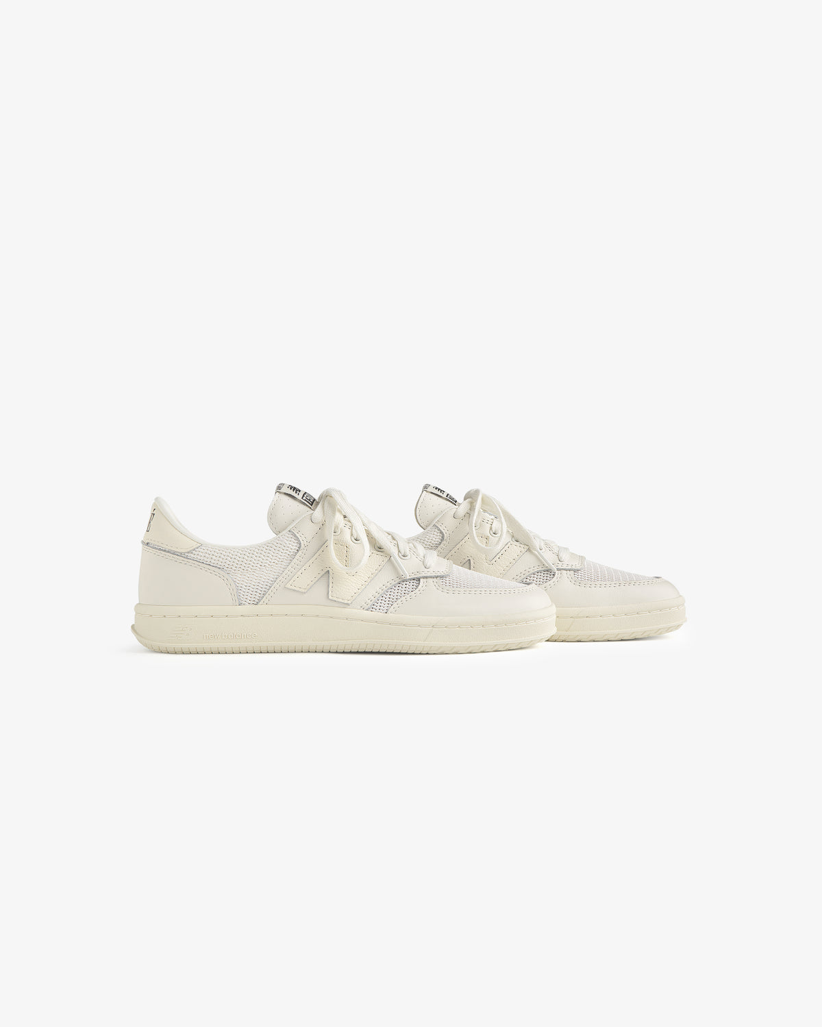 The ALD / New Balance T500 Tennis Oxfords feature off-white textured uppers and laces, displayed on a white background.