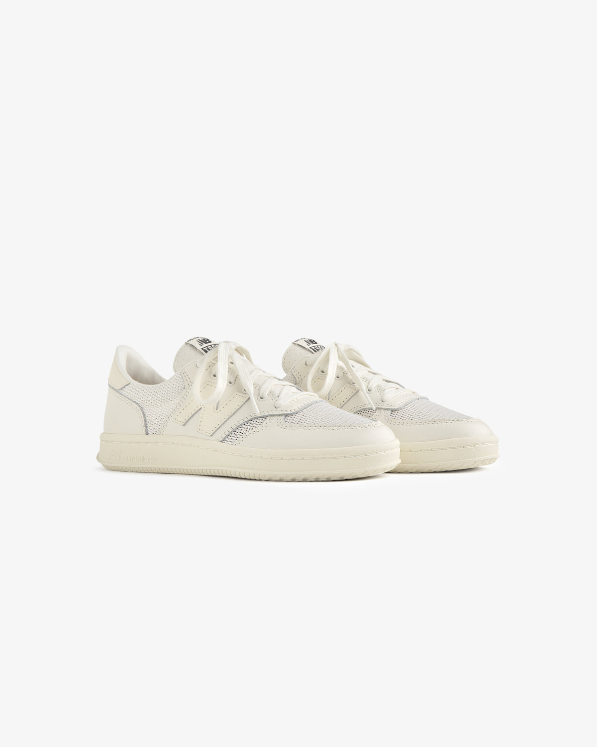 ALD / New Balance T500 Tennis Oxfords: white low-top sneakers with laces, textured details, off-white rubber soles.