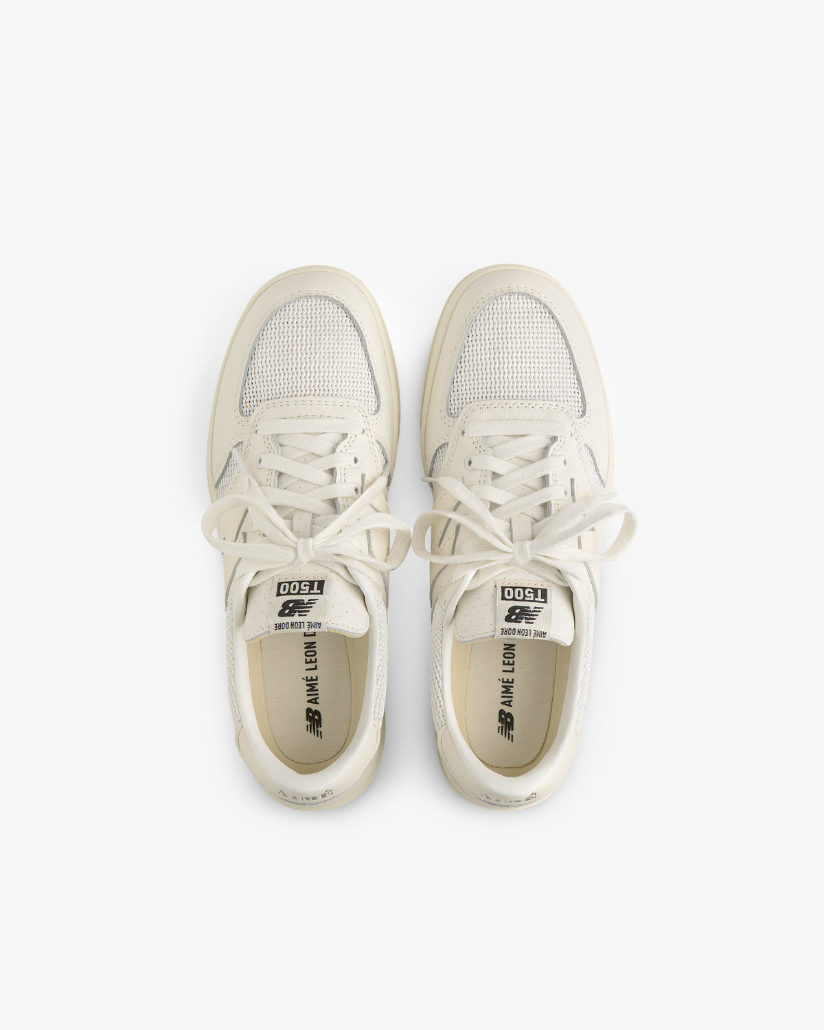 A pair of white ALD / New Balance T500 Tennis Oxfords viewed from above on a plain white background.
