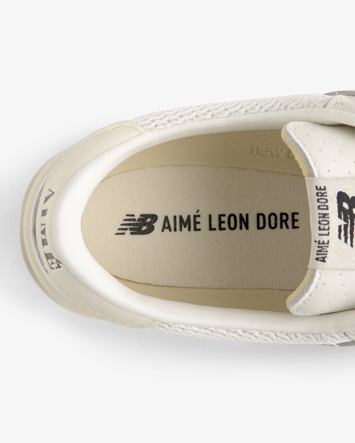 Top view of ALD / New Balance T500 Tennis Oxfords with branding on the insole and heel.
