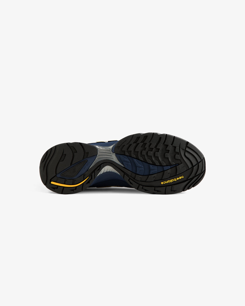 The image shows the black, blue, and yellow treaded sole of an ALD / New Balance RC56 shoe against a white background.